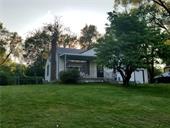 A house with a tree in the background